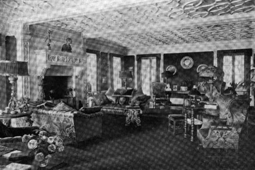 A photograph of the living room and inscribed fireplace, taken circa June, 1907.