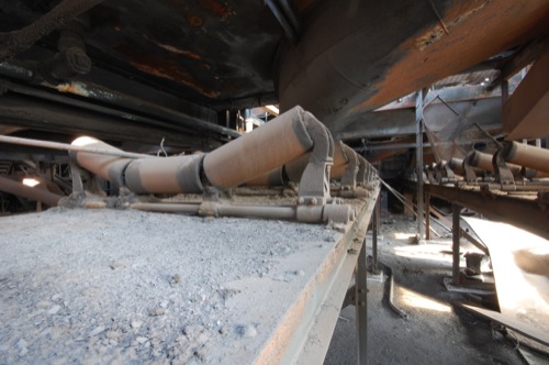 An undercarriage view of the conveyor belt rollers.