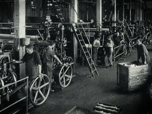 A historical photo of factory loom workers at the Scranton Lace Company.